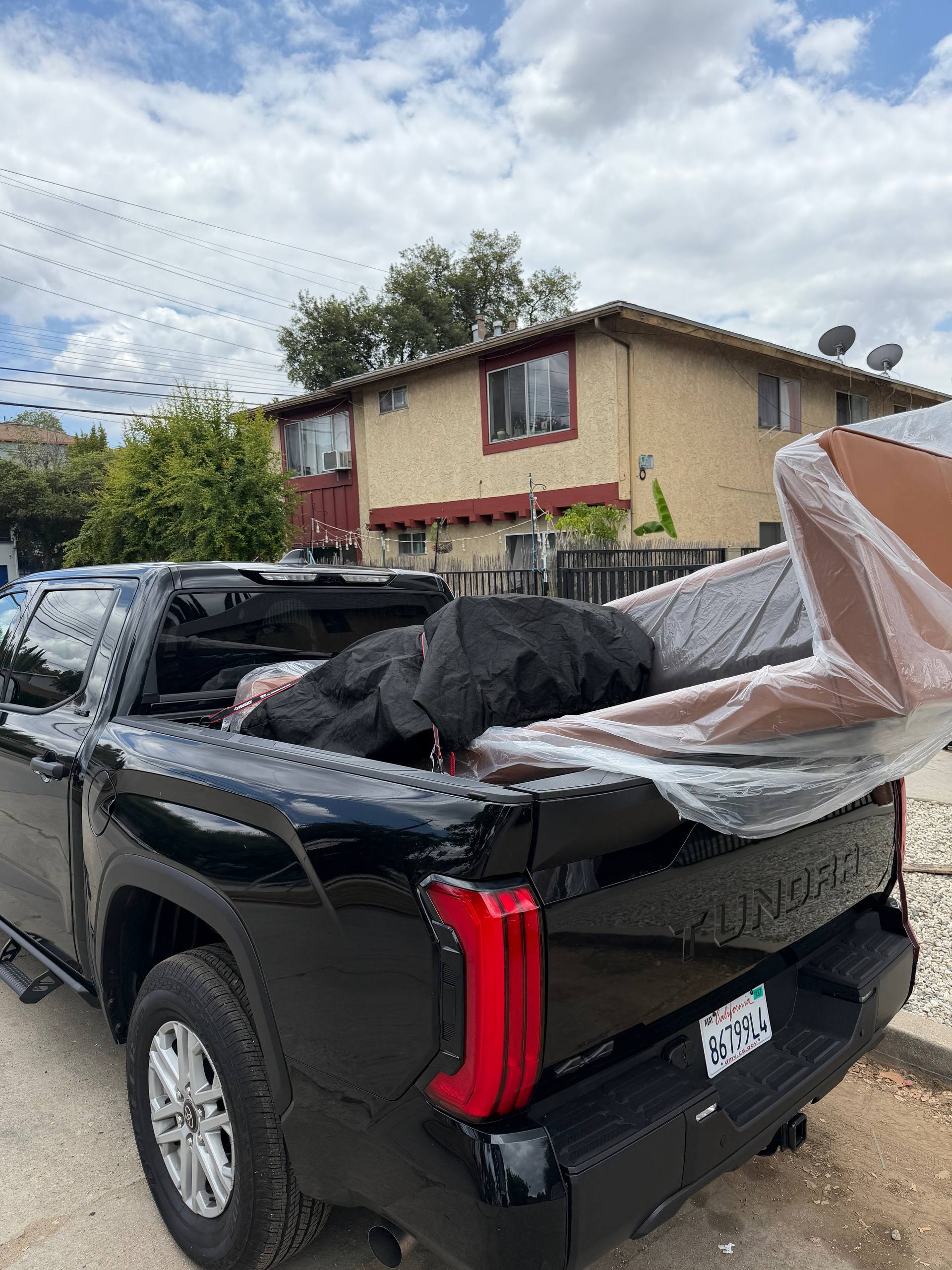 25/7 crew member carrying a sofa to the truck during a furniture removal