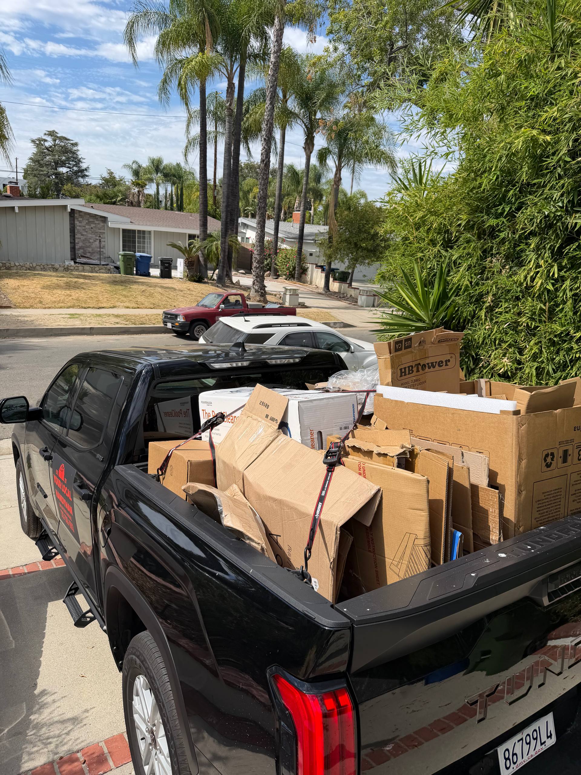 25/7 truck loaded with yard debris and junk after a cleanout